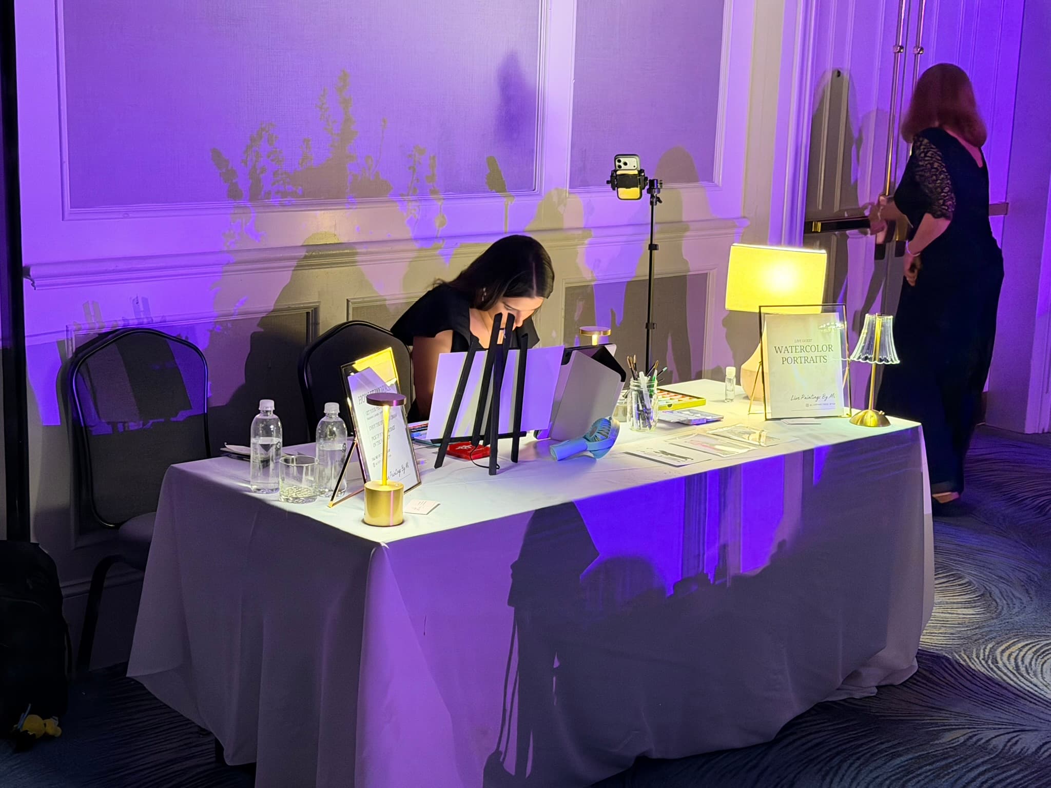 Miriam painting at the event